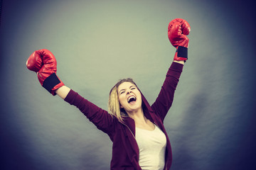 Woman winner wearing boxing gloves
