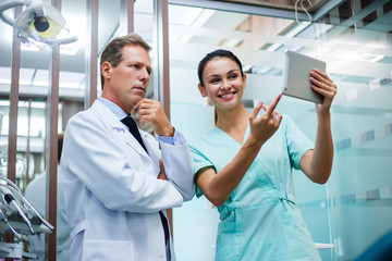 We have medical results. Dentist discussing with his assistant medical results in dentist’s office