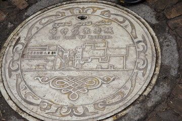 Obraz na płótnie Canvas Sewer cover with stamp of Old Town Kashgar, Xinjiang, China