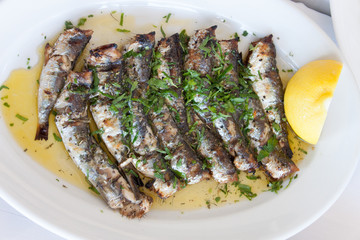 Roasted sardines in plate with lemon