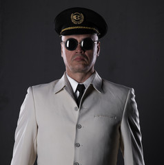 ship captain in a white suit