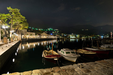 Fototapeta na wymiar Fishing boats at the waterfront at night. Coastal town.