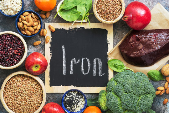 Foods high in iron. Vegetables, fruits rich in iron on a rustic background. Top view, flat lay, copy space.