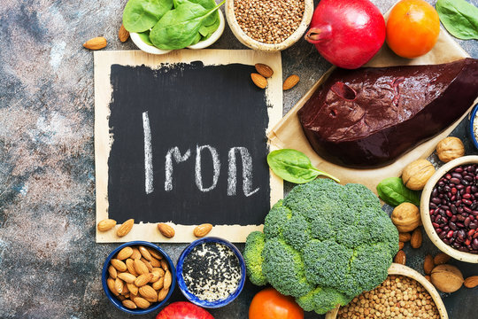Healthy food with iron content. Vegetables, fruits, beef liver rich in iron on a rustic background. Top view, flat lay, copy space.