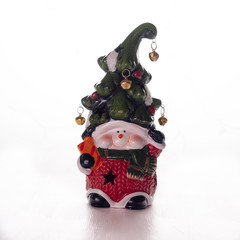 Bright toy dwarf with a cheerful face and a bell on a hat on a white background. New year, Christmas decoration.