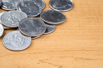US QUARTER COINS ON WOODEN TABLE FOR BACKGROUND / COPY SPACE