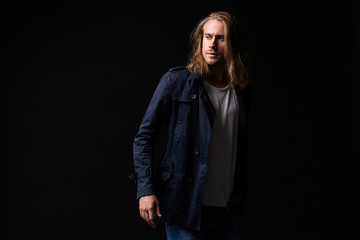 handsome young and fit man posing in casual clothes, wearing jacket.