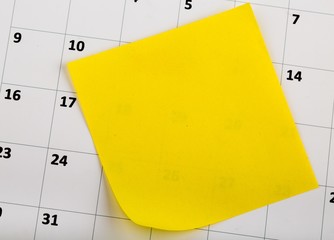 Yellow Sticky Note on a Sheet of a Calendar