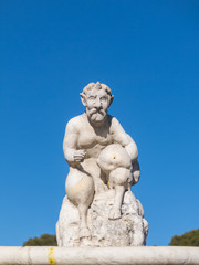 Fototapeta na wymiar Cupid statue in the fountain of the Garden of Roses in Buen Retiro Park. Madrid