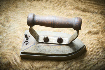 Close up of vintage old rusty iron on sack cloth. Selective focus