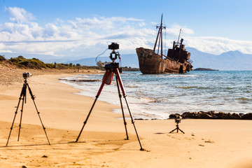 Camera on tripod and shipwreck
