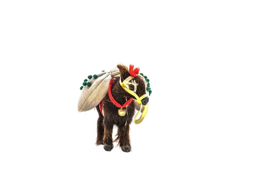 Miniature toy of wool in the form of a donkey with a bag