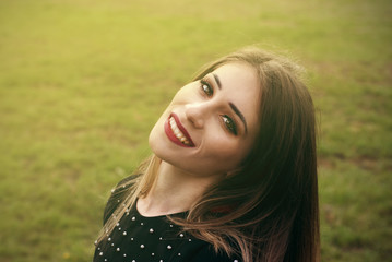 Portrait of a beautiful fashion young women smiling, with red lips, in park, Copy space.