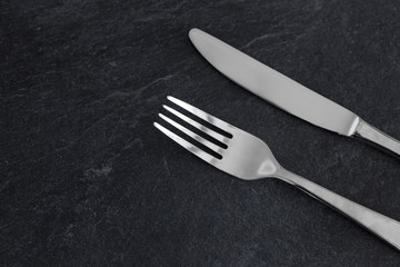 table setting, cutlery and eating concept - close up of fork and knife