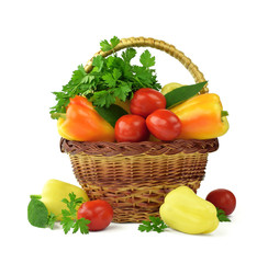 Fresh peppers, tomatoes, greens in a basket. Isolated on white. Diet, proper nutrition. Vegetables.