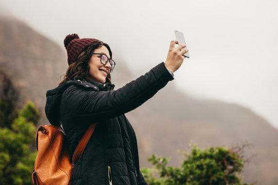 Traveler talking a selfie on hill top