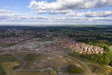 Aerial new housing estate construction on green belt land UK