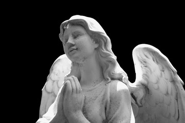Figure of angel of death. Ancient statue isolated on black background.