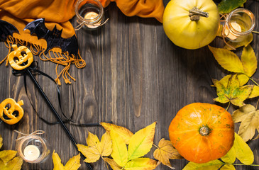 Background with pumpkins, autumn leaves and candles. Halloween style