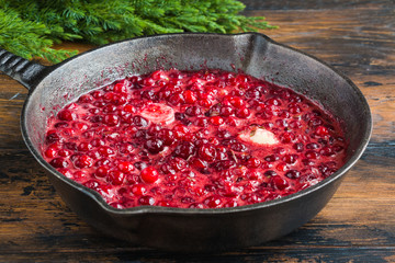 Fresh homemade cranberry sauce for turkey or chicken in black pan