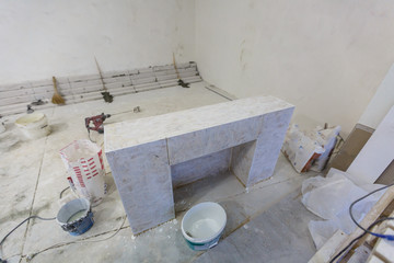 Indoor DIY project: building fireplace in the house: laying bricks. Selective focus