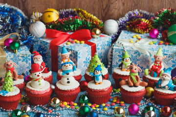 Christmas cupcakes with colored decorations, soft focus background