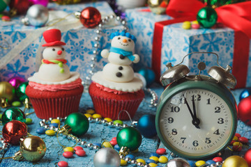 Christmas cupcakes with colored decorations, soft focus background