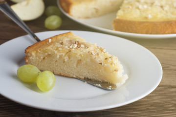 Homemade apple pie with nuts. Autumn food concept. Pie and fall fruits: apples, grapes and nuts.