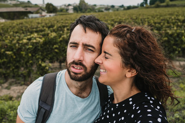 .Young couple in love, touring the vineyards of France at the time of grape harvest. Fun, natural and affectionate. Lifestyle.