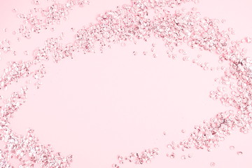 Festive pink background. Shining sequins on light pink pastel background. Christmas. Wedding. Birthday. Happy woman's day. Mothers Day. Valentine's Day. Flat lay, top view, copy space. 