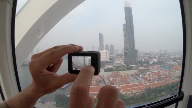 Recording view of Bangkok cityscape from ferris wheel, POV