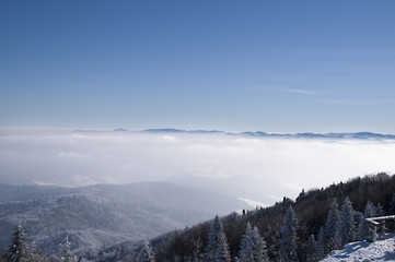 Fototapeta na wymiar winter mountains up above the clouds