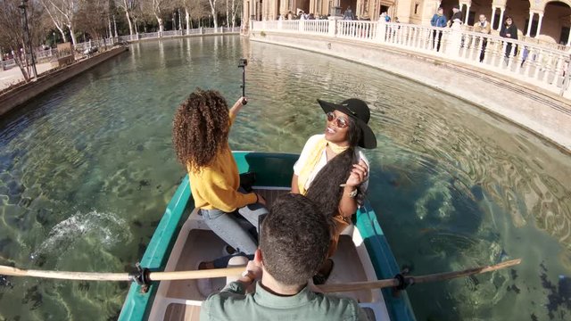 POV, people pose in rowboat
