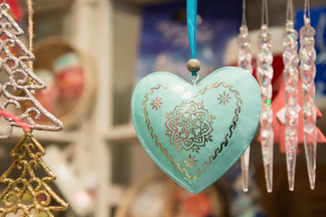 Obraz premium Christmas heart in fair kiosk with red handcrafted xmas decorations.