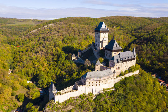 Aerial view of Karlstejn castle. Castle was founded by Holy Roman Emperor and king of Bohemia Charles IV in 14th century. Beautiful gothic castle Karlstejn in the Czech Republic from drone view.