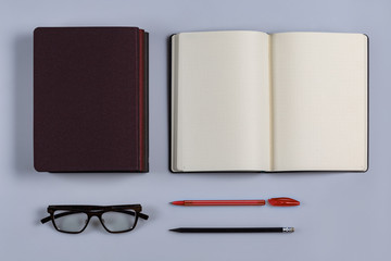 An empty outdoor diary with a pen and pencil and glasses