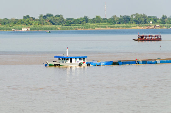 Cargo ship on the Mekong river in Cambodia, overloaded and low in the water