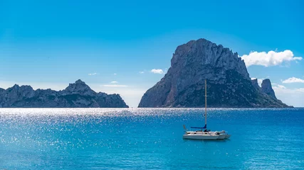 Foto op Aluminium Ibiza, Cala d’Hort beach, beautiful sunny seascape with a sailboat and rocks in the sea   © Pascale Gueret
