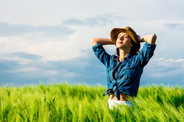 Fototapeta premium portrait of the beautiful young woman standing in the field