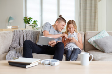 Siblings spending time together at home