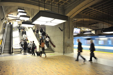 Commuters exiting a metro rail station