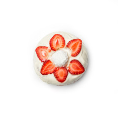 Donut with white cream and strawberry slices, isolated on white background. Top view.