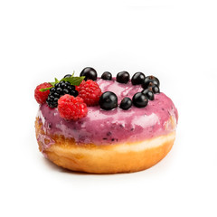 Donut with pink cream and berries, isolated on white background. View from side.