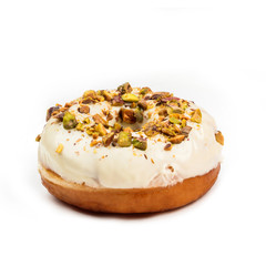 Donut with white cream and hazelnut core, isolated on white background. View from side.