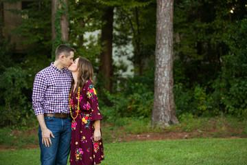 Mom and Dad Couple Kissing Outside their Home in Fall Clothing 