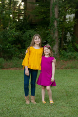 Fototapeta premium Two sisters outside their Home Hugging