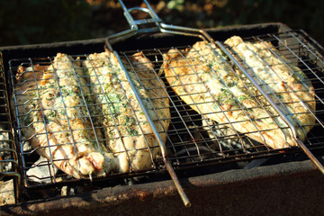 Preparation of fish mackerel on the grill. Close-up. Background.