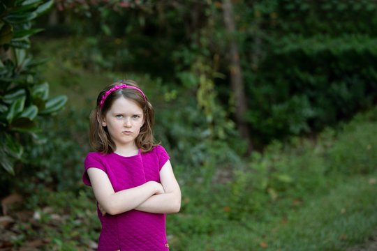 Sullen Little Girl With Attitude Outside with Arms Crossed