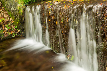 Beautiful decorative stone waterfall pond in garden