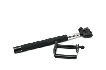 Selfie stick and smartphone on an isolated white background